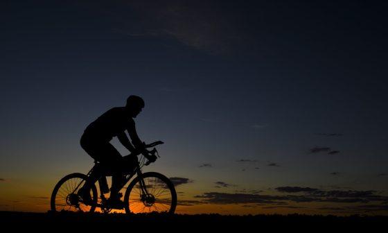 man riding bicycle during nightfall