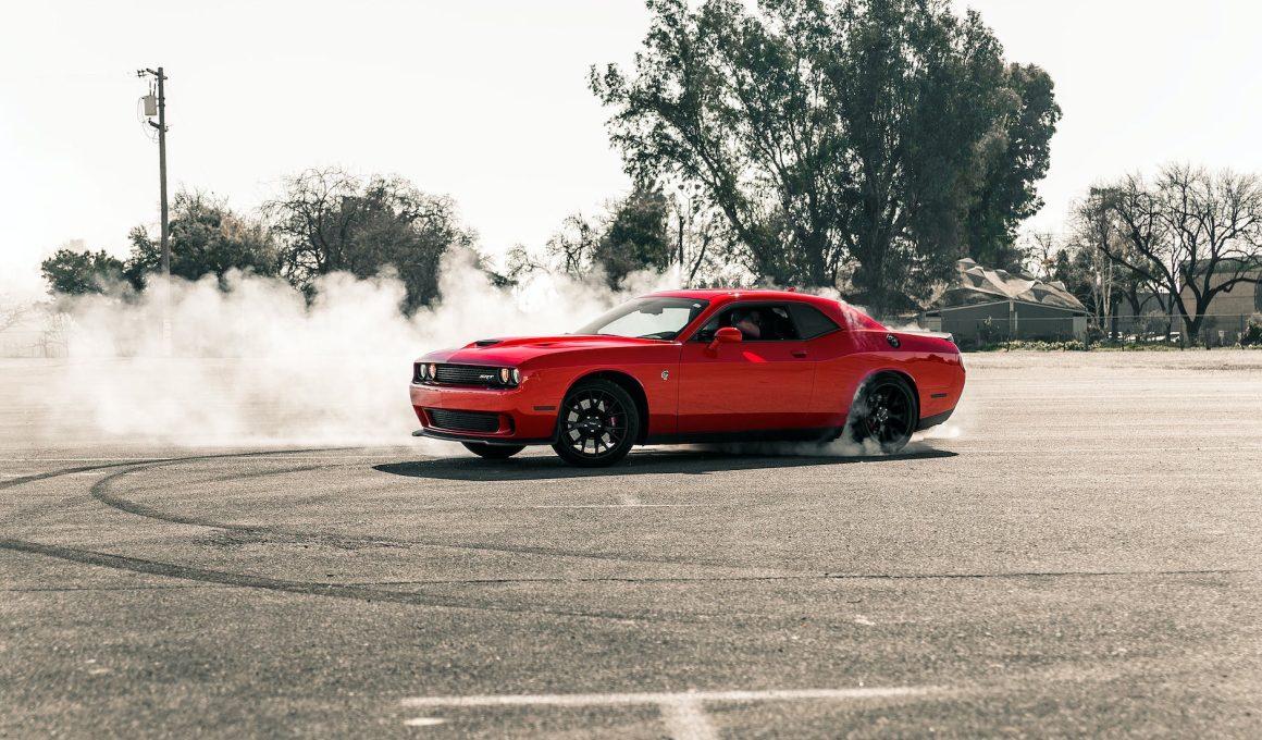 red coupe drifting on asphalt road