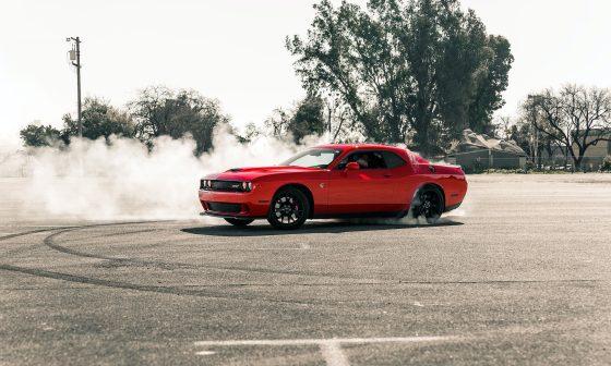 red coupe drifting on asphalt road