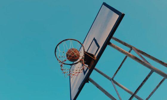 basketball and backboard under blue sky