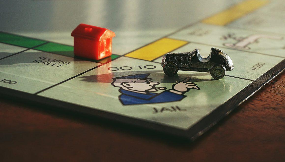 miniature toy car on monopoly board game