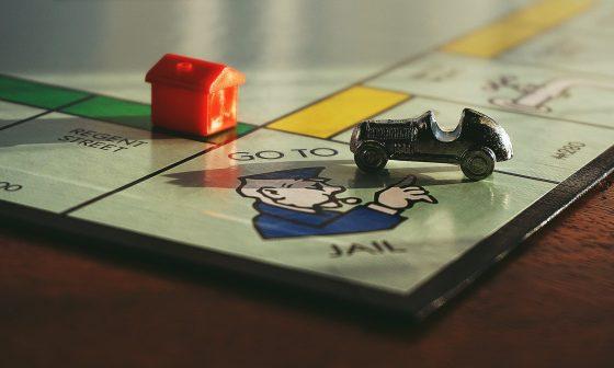 miniature toy car on monopoly board game